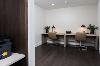 Shared workspace with dual desk stations and task lighting